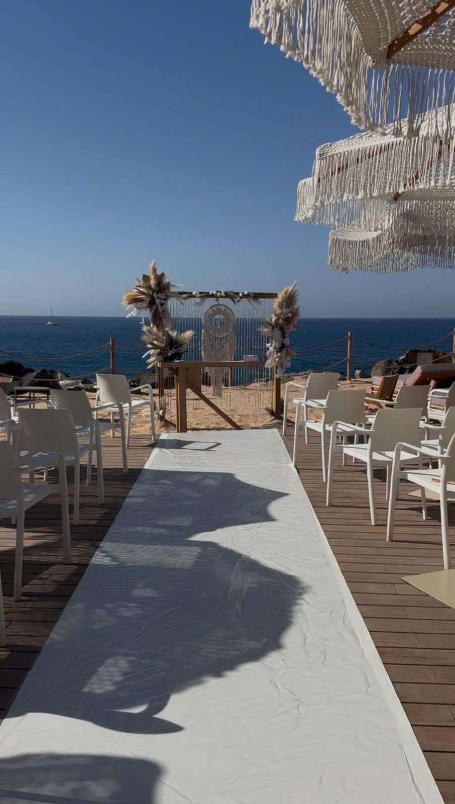A ceremony aisle set on a seafront deck