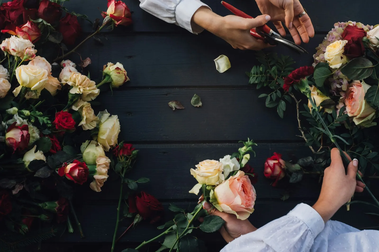 Hands arranging roses for an event